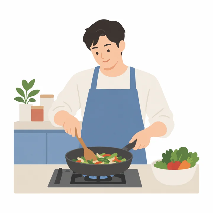 A father in an apron cooks happily in the kitchen.