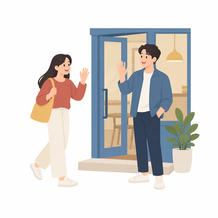Two friends wave and greet each other happily in front of a cafe on the weekend.